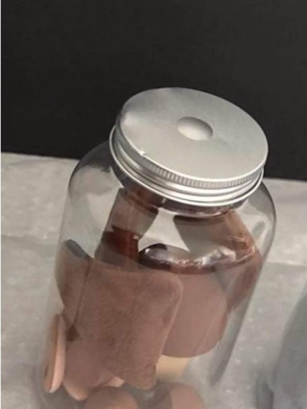 Clear Glass Jar with Silver Screw full od beauty blenders & Makeup plush